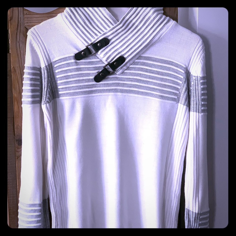 Roman sweater with black buckles on collar.
